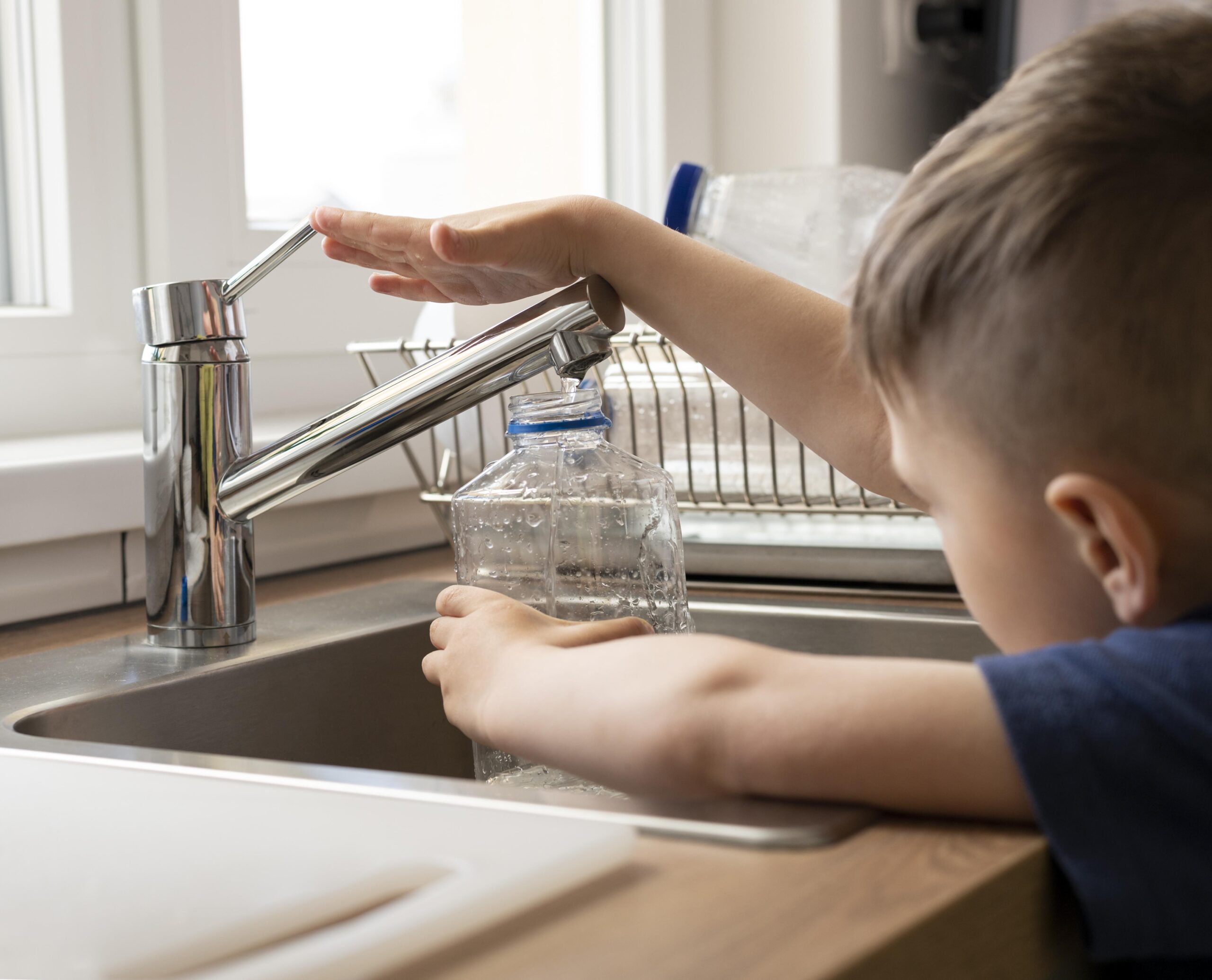 close-up-kid-filling-bottle-with-water Water Treatment Plant Manufactures in Chennai